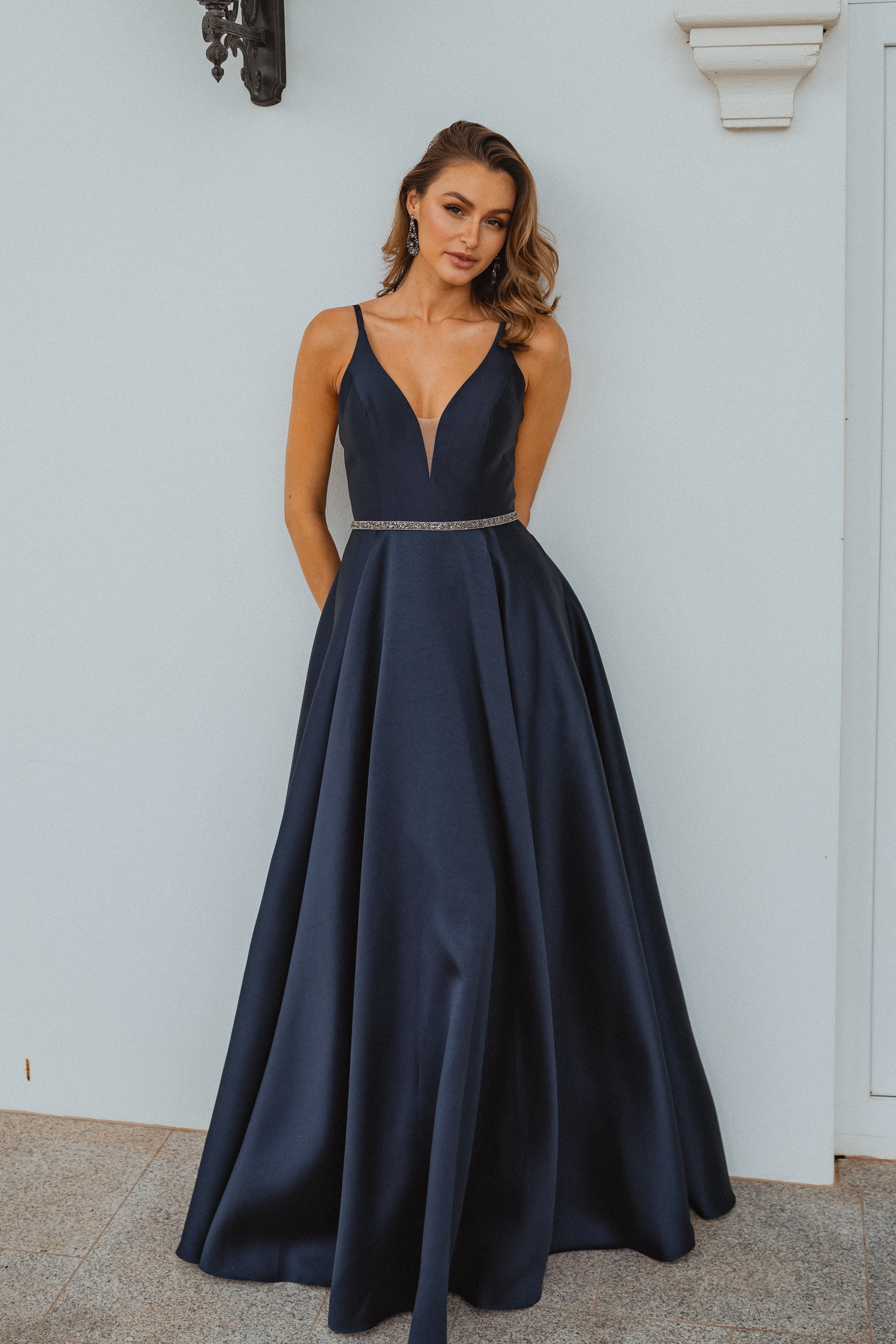 PO896 Linz front of navy blue plunging v neckline, floor length a line, matte satin formal dress